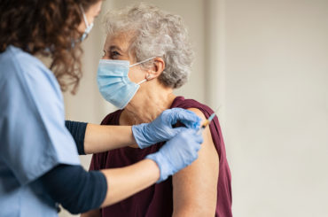 A woman getting a vaccination.